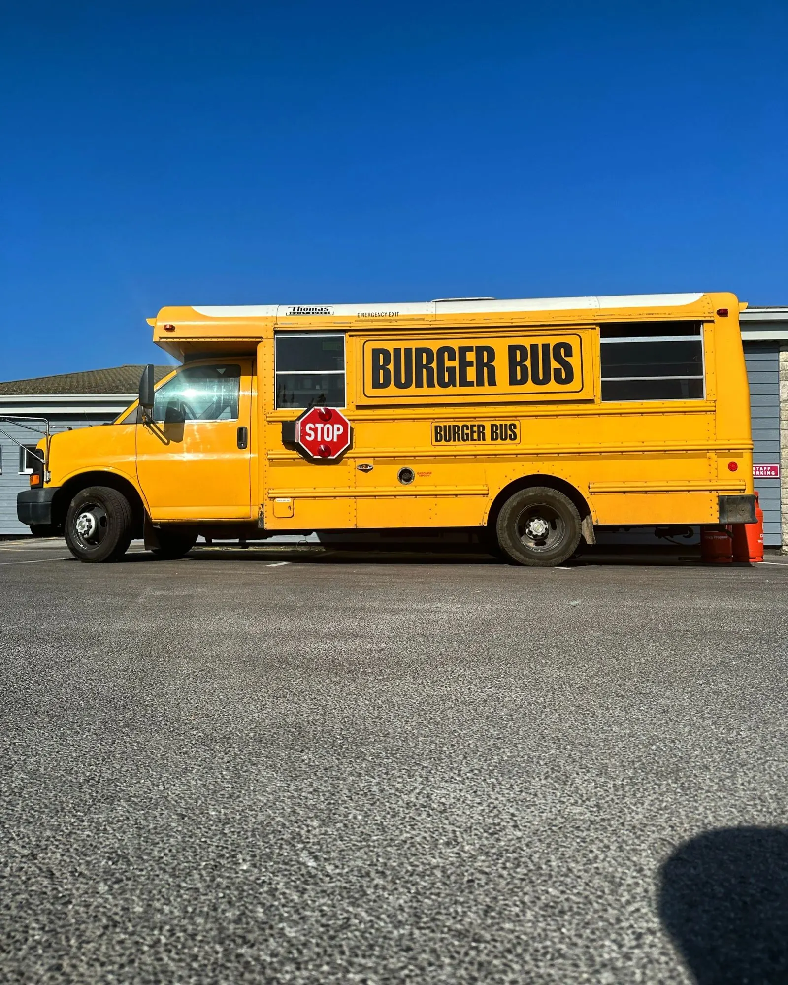 Burger Bus in a car park under blue sky