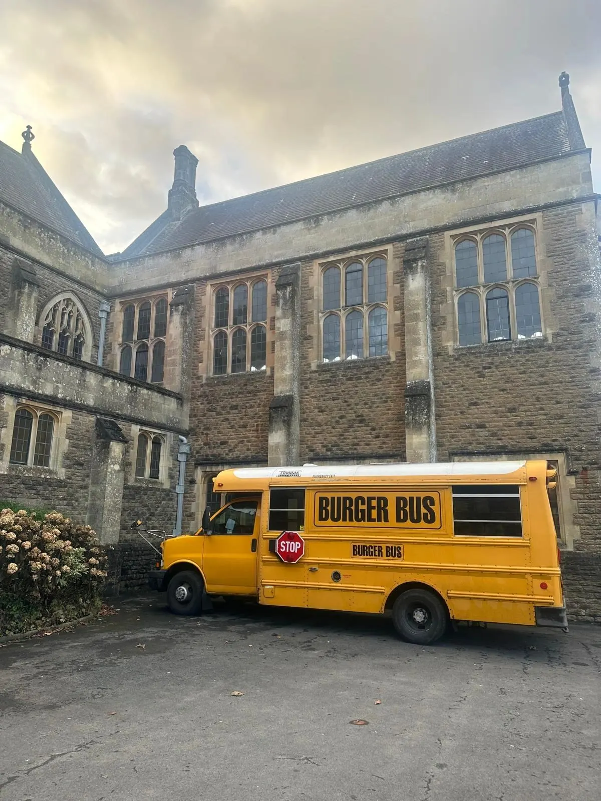Burger Bus parked outside a stone building