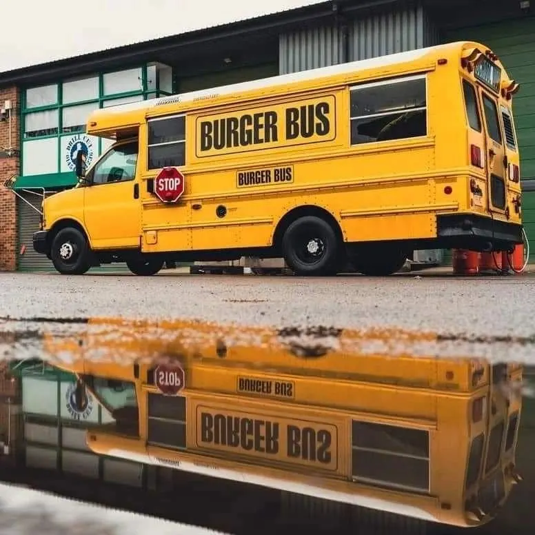 Burger Bus reflected in a puddle