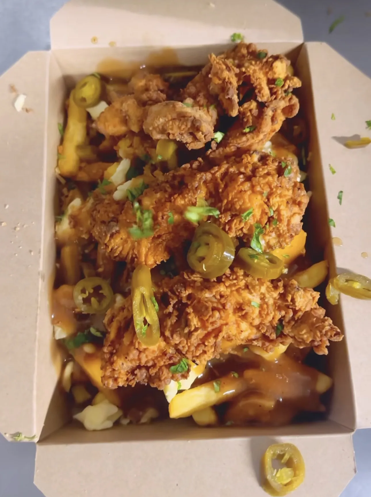 Loaded fries with crispy fried chicken, cheese, gravy and jalapeños